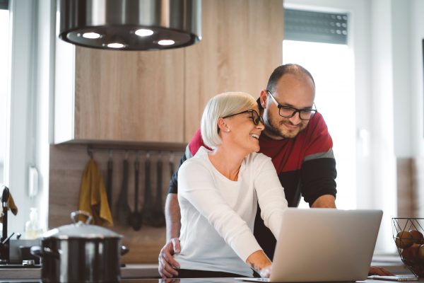 Adult couple looking at computer together.
